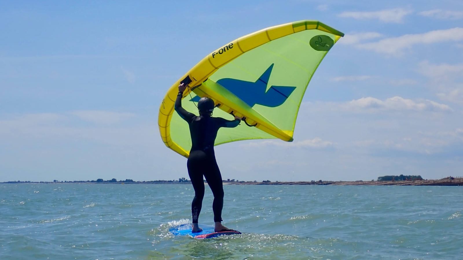 Wing surfing on a non foil board